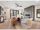 Bright living room featuring a fireplace, hardwood floors, a ceiling fan, and large sliding glass doors at 1516 N Caldwell St, Charlotte, NC 28206