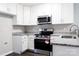 Bright kitchen featuring stainless steel appliances, granite countertops, and white cabinets at 1517 Tiana Way, Rock Hill, SC 29732