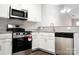 Modern kitchen features stainless steel appliances, granite countertops, and white cabinetry at 1517 Tiana Way, Rock Hill, SC 29732
