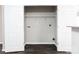 Convenient laundry room with hookups, white wire shelving, and contrasting dark floors at 1517 Tiana Way, Rock Hill, SC 29732