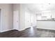 Open-concept living space with sleek wood floors, neutral walls, and a view into the modern kitchen at 1517 Tiana Way, Rock Hill, SC 29732