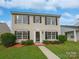 Charming two-story home with manicured lawn, lush bushes and complementary black shutters at 1555 Andora Dr, Rock Hill, SC 29732