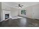 Open living room featuring a fireplace, hardwood floors, and large window at 1555 Andora Dr, Rock Hill, SC 29732