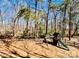 Spacious backyard with swing set, playground, mature trees, and partial fencing at 177 Highland Woods Ct, Denver, NC 28037