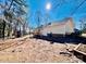 Large wooded backyard featuring a playset, mature trees, and partial fencing at 177 Highland Woods Ct, Denver, NC 28037