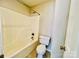 Full bathroom with a combined tub and shower, neutral tile flooring, and white toilet at 177 Highland Woods Ct, Denver, NC 28037