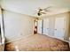 A cozy bedroom features a ceiling fan, carpet, and white doors, offering a comfortable space at 177 Highland Woods Ct, Denver, NC 28037
