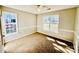 A spacious bedroom with natural light from two windows, carpet flooring, and neutral colors at 177 Highland Woods Ct, Denver, NC 28037