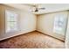 A bright bedroom features neutral paint, a ceiling fan, and windows allowing ample natural light at 177 Highland Woods Ct, Denver, NC 28037