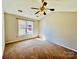 A comfy bedroom features carpet, a vaulted ceiling with fan, and natural light from the window at 177 Highland Woods Ct, Denver, NC 28037