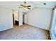 Spacious bedroom with neutral carpet, lighted ceiling fan, and ensuite bathroom access at 177 Highland Woods Ct, Denver, NC 28037