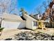 Lovely home with attached garage, covered front porch, and well-maintained driveway at 177 Highland Woods Ct, Denver, NC 28037