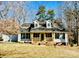 Charming home with a covered front porch and well-manicured yard, nestled among mature trees at 177 Highland Woods Ct, Denver, NC 28037