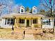 Welcoming covered front porch with brick base and wood railings, offering curb appeal at 177 Highland Woods Ct, Denver, NC 28037