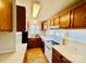 A bright kitchen offers wood cabinets, a white countertop, and essential appliances for cooking needs at 177 Highland Woods Ct, Denver, NC 28037