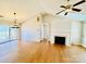 Bright and airy living room featuring hardwood floors, fireplace, and access to a back deck at 177 Highland Woods Ct, Denver, NC 28037