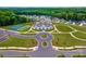 Aerial view of the community with clubhouse, pool, tennis courts, and lush green spaces at 2014 Mantle Ridge Dr, Indian Trail, NC 28079