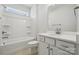 Bright bathroom featuring a tub with shower, white vanity with sink, and tiled floors at 2014 Mantle Ridge Dr, Indian Trail, NC 28079