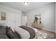 Cozy bedroom showcasing a comfortable bed, artwork, closet, and natural light from a window at 2014 Mantle Ridge Dr, Indian Trail, NC 28079