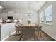 Bright dining area featuring an elegant chandelier, modern table set, and natural light from large windows at 2014 Mantle Ridge Dr, Indian Trail, NC 28079