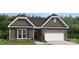 Charming single Gathering home boasting stone accents, neutral colors and a two car garage at 2014 Mantle Ridge Dr, Indian Trail, NC 28079
