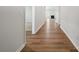 Bright hallway with wood flooring leading to a living room with a fireplace at 2014 Mantle Ridge Dr, Indian Trail, NC 28079