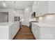 Bright kitchen featuring white cabinets, stainless steel appliances, and wood floors at 2014 Mantle Ridge Dr, Indian Trail, NC 28079