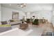 Bright living room showcasing stylish furniture, open layout connecting to kitchen and dining area, and hardwood floors at 2014 Mantle Ridge Dr, Indian Trail, NC 28079