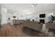 Open-concept living room with a fireplace, hardwood floors, and a view of the modern kitchen and dining area at 2014 Mantle Ridge Dr, Indian Trail, NC 28079