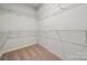 Walk-in closet featuring wire shelving, carpeted floor, and ample storage space for clothing and accessories at 2014 Mantle Ridge Dr, Indian Trail, NC 28079