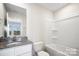 This bathroom features a granite countertop, white cabinets, and a shower and tub combination at 225 Kennerly Ave # A, Mooresville, NC 28115