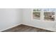 This bedroom has wood flooring, white walls, and two windows to provide natural light at 225 Kennerly Ave # A, Mooresville, NC 28115