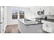Contemporary kitchen with white cabinets, granite countertops, stainless steel appliances, and ample natural light at 225 Kennerly Ave # A, Mooresville, NC 28115