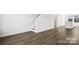 Spacious living area with hardwood floors, a staircase, and a view of the modern kitchen at 225 Kennerly Ave # A, Mooresville, NC 28115