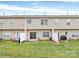 Backyard with a small patio, green grass, and exterior of building at 2313 Calabassas Ln, Matthews, NC 28105