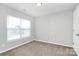 Simple bedroom features carpeted floors and a window with natural light at 2313 Calabassas Ln, Matthews, NC 28105