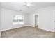 Spacious bedroom featuring neutral walls, plush carpet, and a ceiling fan at 2313 Calabassas Ln, Matthews, NC 28105