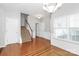 Welcoming foyer featuring hardwood floors, staircase, and chandelier lighting at 2313 Calabassas Ln, Matthews, NC 28105
