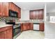 Well-equipped kitchen boasts wooden cabinets, tile backsplash, and a full suite of modern appliances at 2313 Calabassas Ln, Matthews, NC 28105