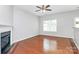 Cozy living room features hardwood floors, a modern fireplace, and a ceiling fan at 2313 Calabassas Ln, Matthews, NC 28105