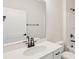 Bathroom features a single vanity with black hardware, framed mirror, and a bathtub with a shower at 237 Miramar Dr, York, SC 29745