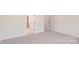 Bedroom with neutral carpet, showcasing an open doorway, and clean white baseboards and walls at 237 Miramar Dr, York, SC 29745