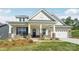 Inviting exterior with covered porch, brick accents, and two-car garage enhance this charming home at 237 Miramar Dr, York, SC 29745