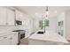 Bright kitchen features white cabinets, modern appliances, white backsplash, and a center island at 237 Miramar Dr, York, SC 29745