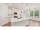 Modern kitchen with white cabinets, a center island, pendant lighting, and stainless steel appliances at 237 Miramar Dr, York, SC 29745