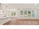 Open concept living area with hardwood floors, recessed lighting and backyard views through three large windows at 237 Miramar Dr, York, SC 29745