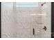 Walk-in shower featuring marble-look tile and a glass door, enhancing the bathroom's luxurious feel at 237 Miramar Dr, York, SC 29745