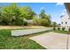 Backyard featuring retaining wall, grass, and concrete pad at 2425 Ellen Ave, Charlotte, NC 28208