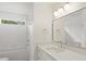 Bright bathroom with soaking tub, shower, white vanity and framed mirror at 2425 Ellen Ave, Charlotte, NC 28208