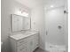 Modern bathroom features a walk-in shower and a white vanity with a framed mirror at 2425 Ellen Ave, Charlotte, NC 28208